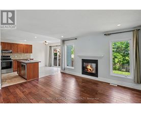 A large open living room with a fireplace and sliding glass doors.
