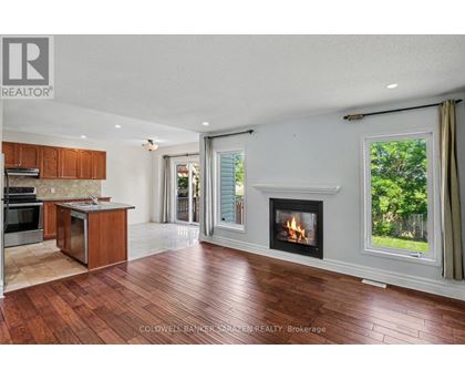 A large open living room with a fireplace and sliding glass doors.