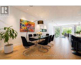 A modern dining room with a glass table and chairs.