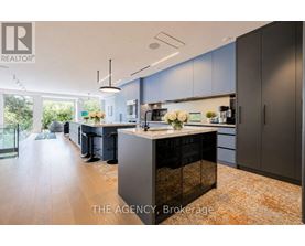 A modern kitchen with dark grey cabinets and a central island.