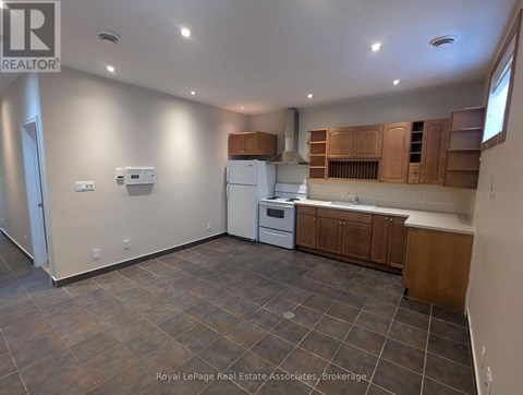 A kitchen with brown cabinets and a white fridge.