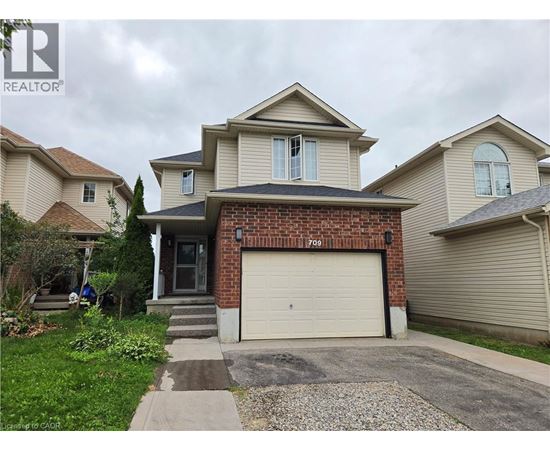 A house with a garage and a driveway in front.