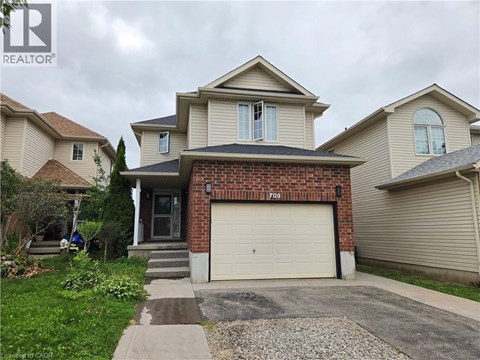 A house with a garage and a driveway in front.