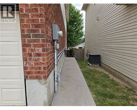 A white door is on the left of a brick wall.