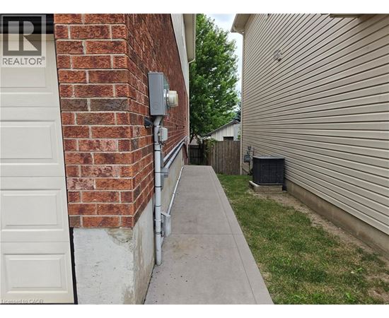 A white door is on the left of a brick wall.