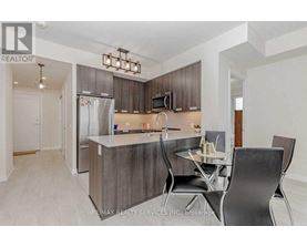 A modern kitchen with a dining table set for two.