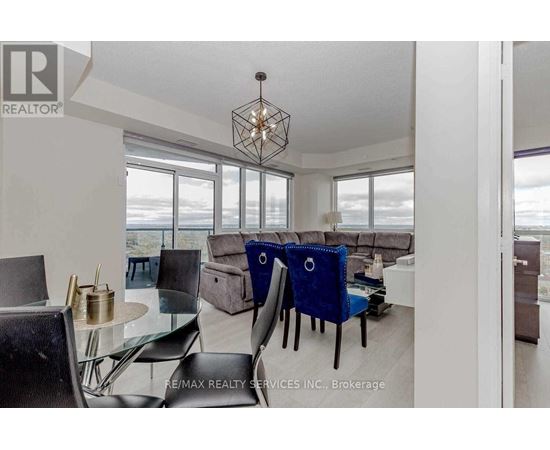 A modern dining room with a glass table and chairs.