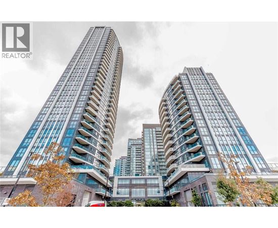 Two tall buildings with balconies are in the foreground with a cloudy sky in the background.