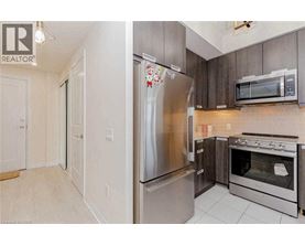 A kitchen with a stainless steel refrigerator and oven.