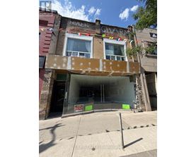 A building with a sign that says "EXP REALTY Brokerage" in front of it.