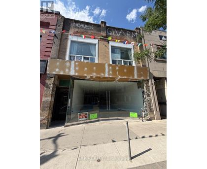 A building with a sign that says "EXP REALTY Brokerage" in front of it.