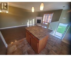 A kitchen with a wooden island and a window.