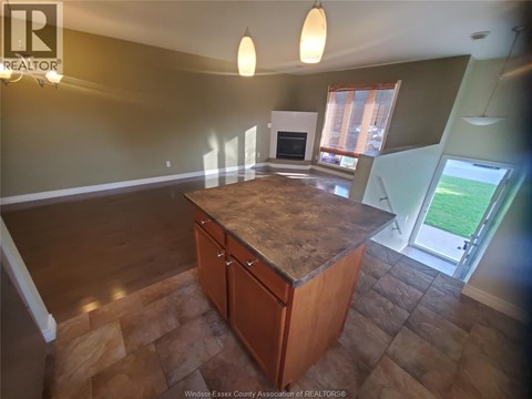 A kitchen with a wooden island and a window.