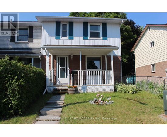A house with a white front porch and a small garden.