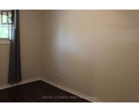 A room with a window and a curtain.