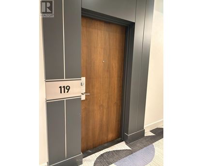 A brown door with a number 119 on it.