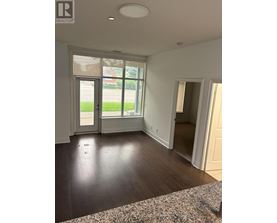 A room with a large window and a sliding glass door.