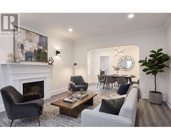 A living room with a fireplace, two chairs, a couch, and a dining table.