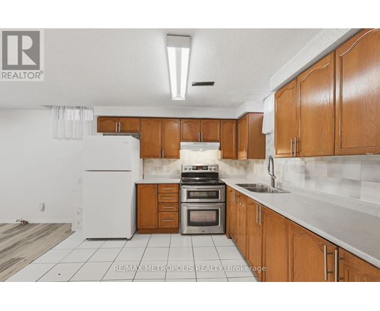 A kitchen with wooden cabinets and a white refrigerator.
