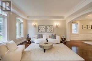 A living room with a white sofa and a coffee table.