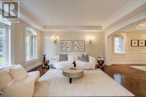 A living room with a white sofa and a coffee table.