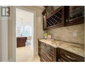 A kitchen with granite countertops and wooden cabinets.