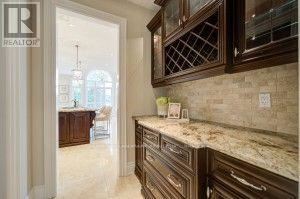 A kitchen with granite countertops and wooden cabinets.