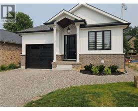 A white house with a black door and windows.