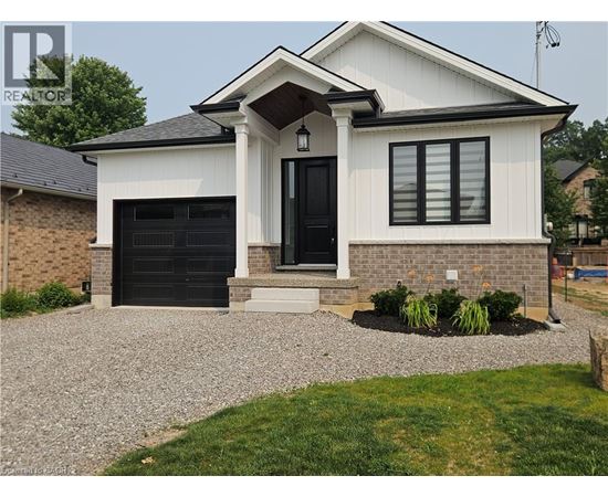 A white house with a black door and windows.