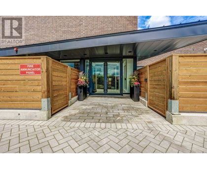 The entrance to a building with a fire annunciator panel on the wall.