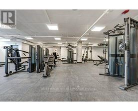 A gym with a variety of equipment including treadmills, weights, and exercise machines.