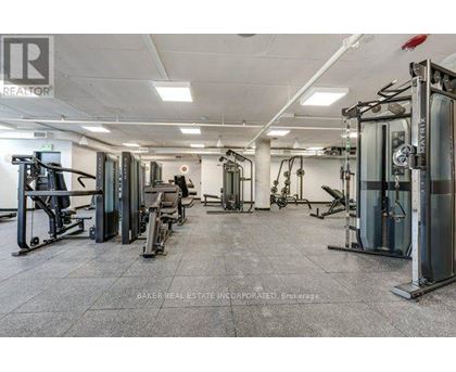 A gym with a variety of equipment including treadmills, weights, and exercise machines.