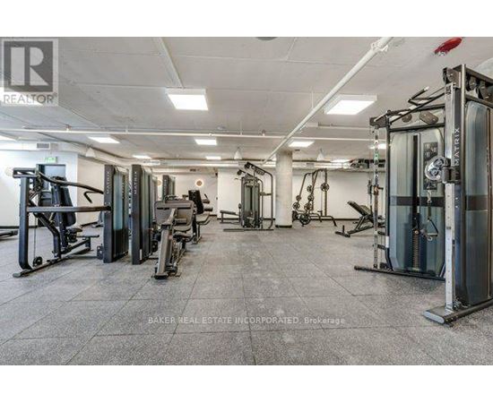 A gym with a variety of equipment including treadmills, weights, and exercise machines.