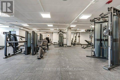 A gym with a variety of equipment including treadmills, weights, and exercise machines.