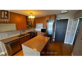 A kitchen with wooden cabinets and granite countertops.