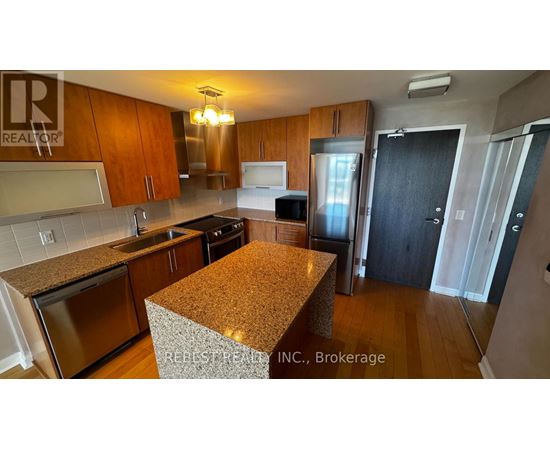 A kitchen with wooden cabinets and granite countertops.