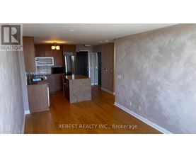 A kitchen area with wooden floors and a countertop.