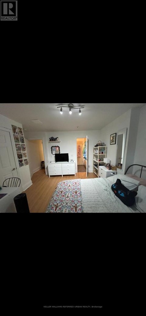 A living room with a white couch and a television.