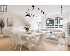 A white dining room with a table set for four.