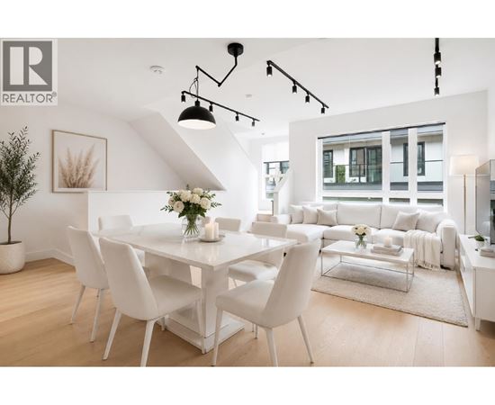 A white dining room with a table set for four.