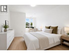 A bedroom with a large bed, a nightstand, and a dresser with a mirror.