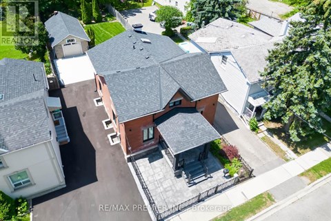 A bird's eye view of a house with a red brick exterior and a grey roof.