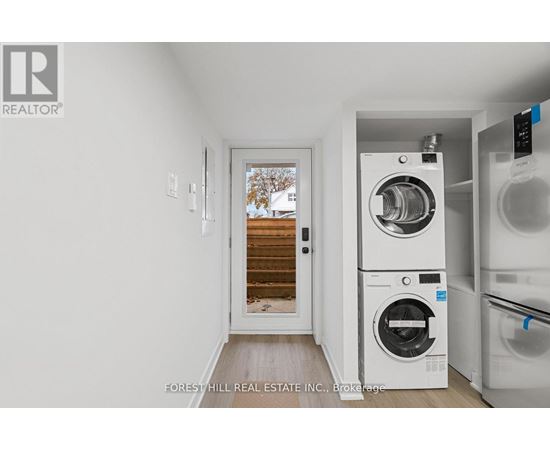 A laundry room with a washer and dryer stacked on top of each other.