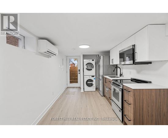 A kitchen with white cabinets and a microwave above the stove.