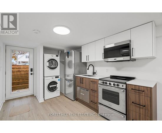 A kitchen with white cabinets and stainless steel appliances.