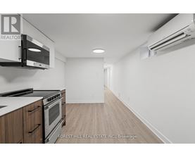 A kitchen with a stove top oven and microwave.