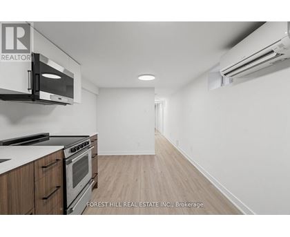 A kitchen with a stove top oven and microwave.