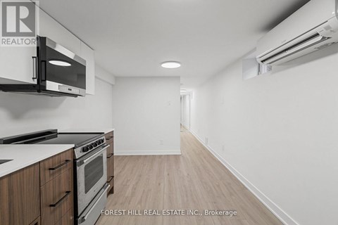 A kitchen with a stove top oven and microwave.