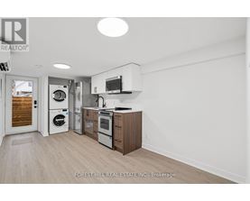 A kitchen with a washer and dryer built in.