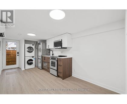 A kitchen with a washer and dryer built in.